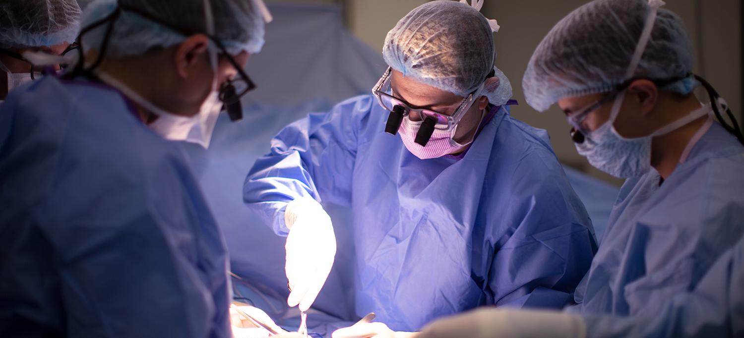 Dr. Omri B. Ayalon, Dr. Jacques H. Hacquebord, and Team Performing Amputation Reconstruction in Operating Room