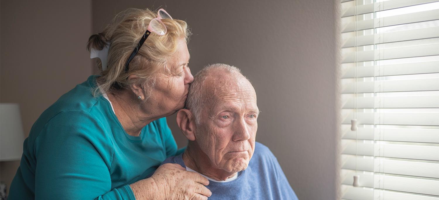 Older Woman Kissing Older Man on Side of Head