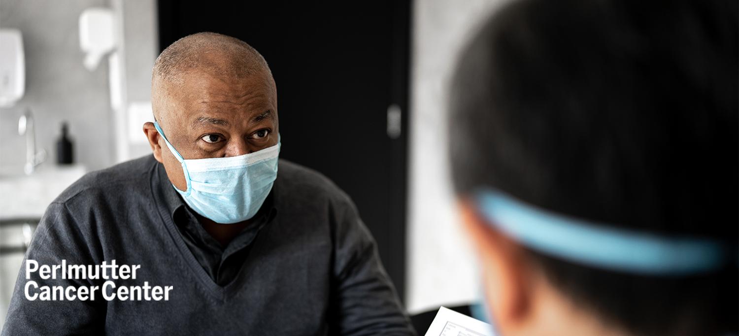Patient Wearing a Mask Speaks with Doctor