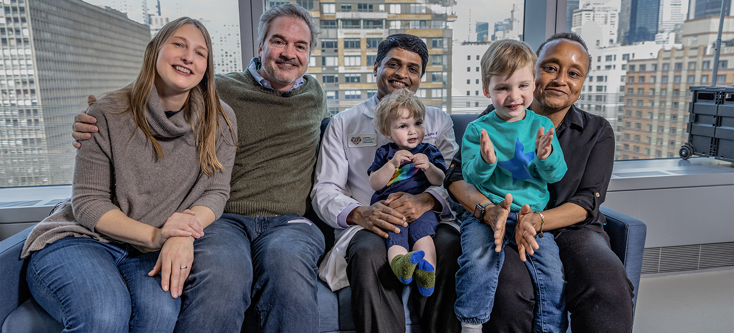 Charlotte Jordan and Eric Hoffman on Couch with Dr. T.K. Susheel Kumar, Holding Finley, and Dr. Gillian L. Henry, Holding Theo