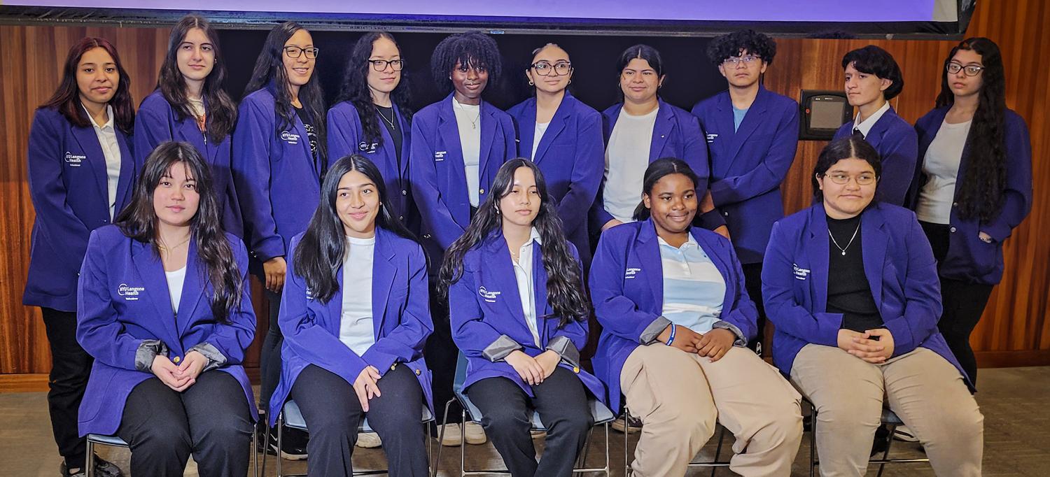 Students in Summer Mentoring Program in Two Rows Wearing Purple NYU Langone Jackets