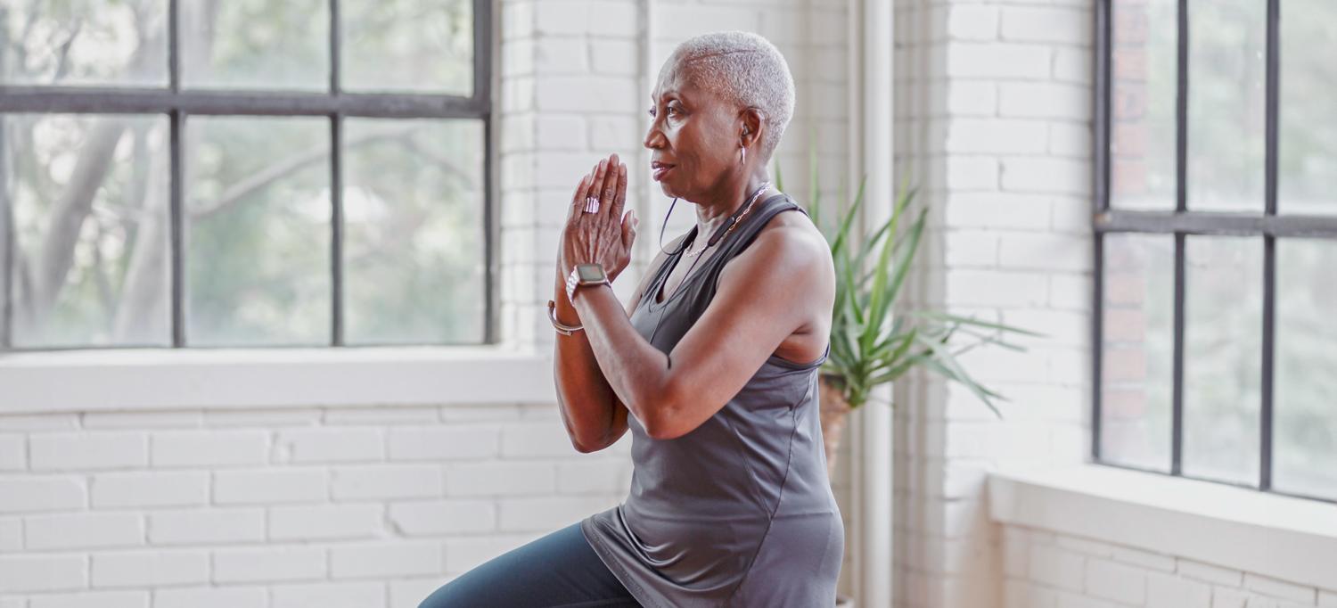 A woman holds a yoga pose.