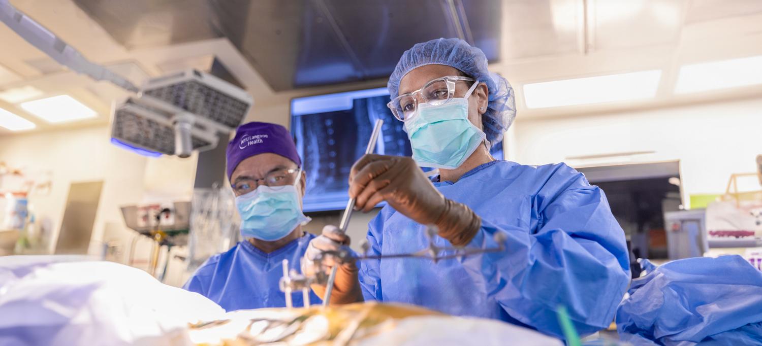 Dr. Charla R. Fischer and Dr. Yong H. Kim perform a surgical procedure in an operating room. 
