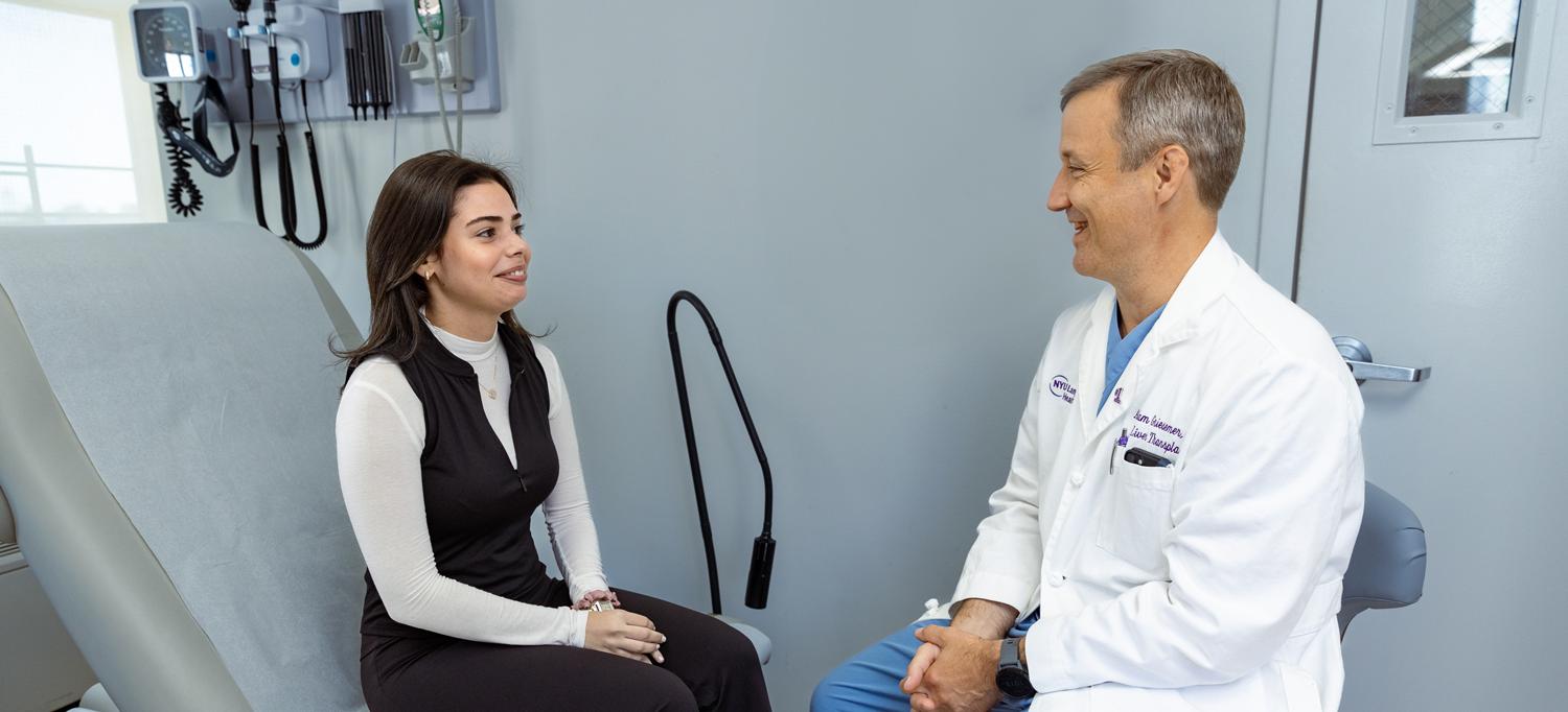 Gonzalez speaks to Dr. Adam Griesemer in an examination room.