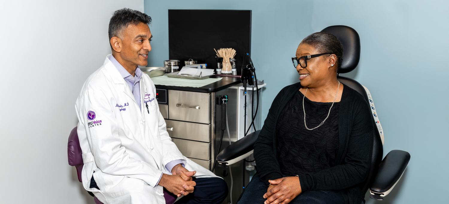 Dr. Milan R. Amin talks with a patient. 