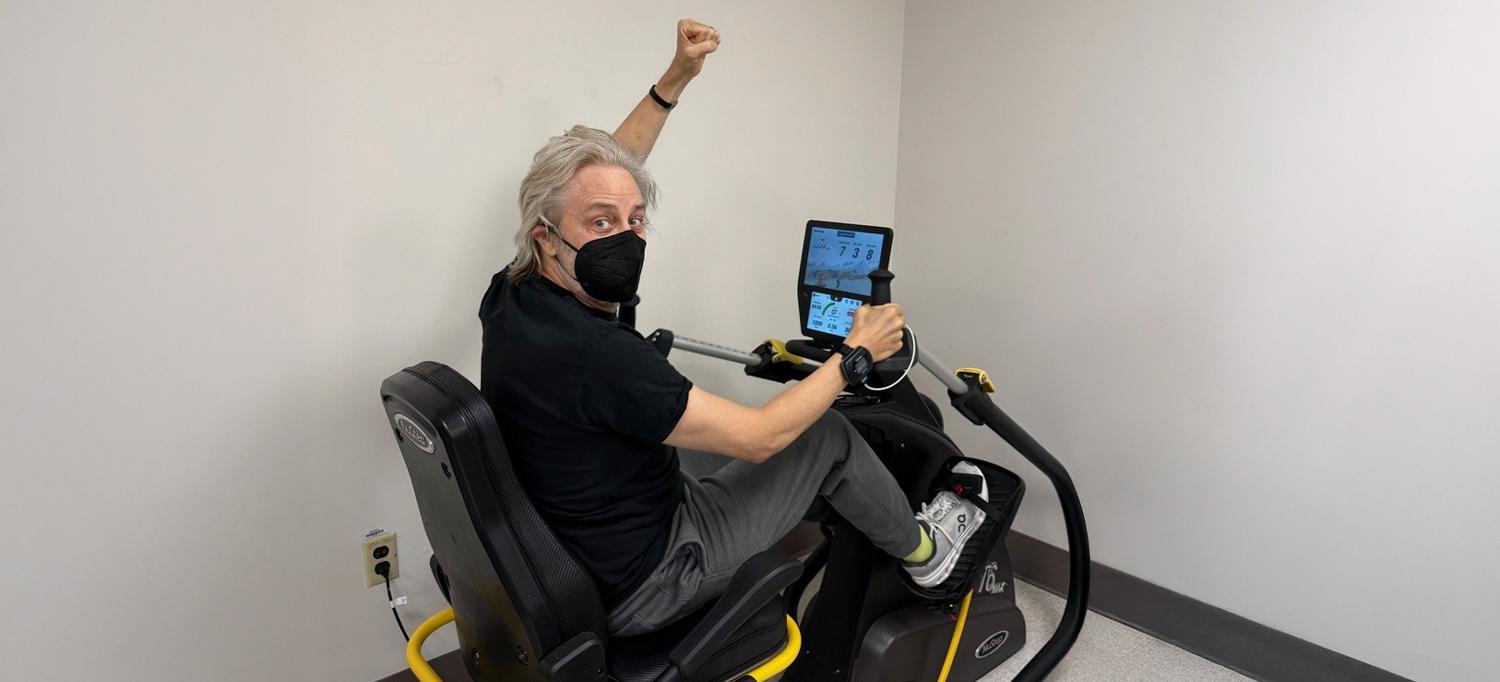 Craig Kanarick riding an exercise bicycle. 