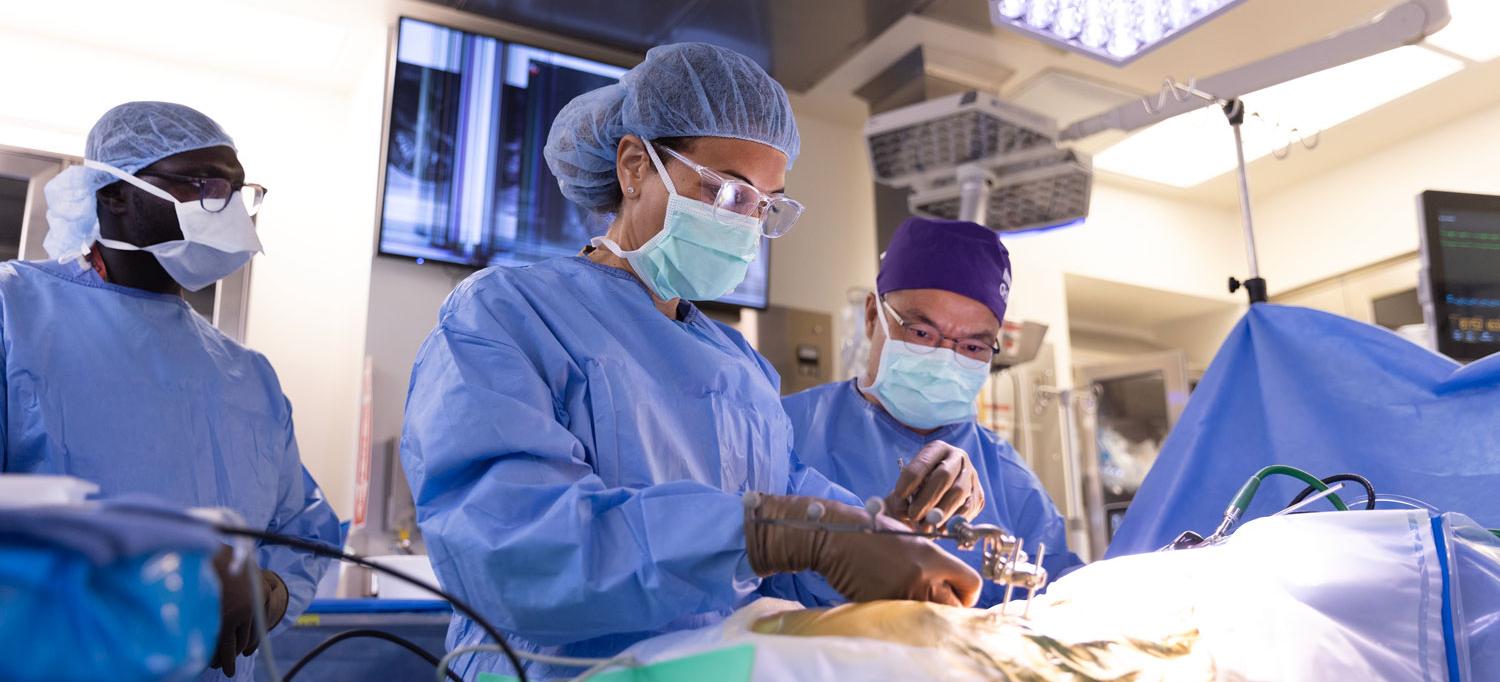 Dr. Charla R. Fischer and Dr. Yong H. Kim operate on a patient.