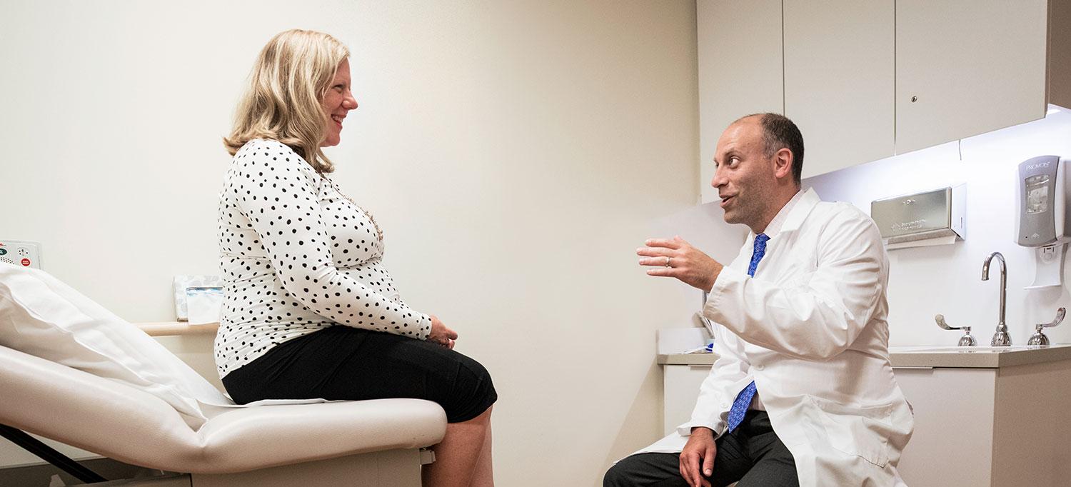 Dr. David P. Hudesman sees a patient in an exam room