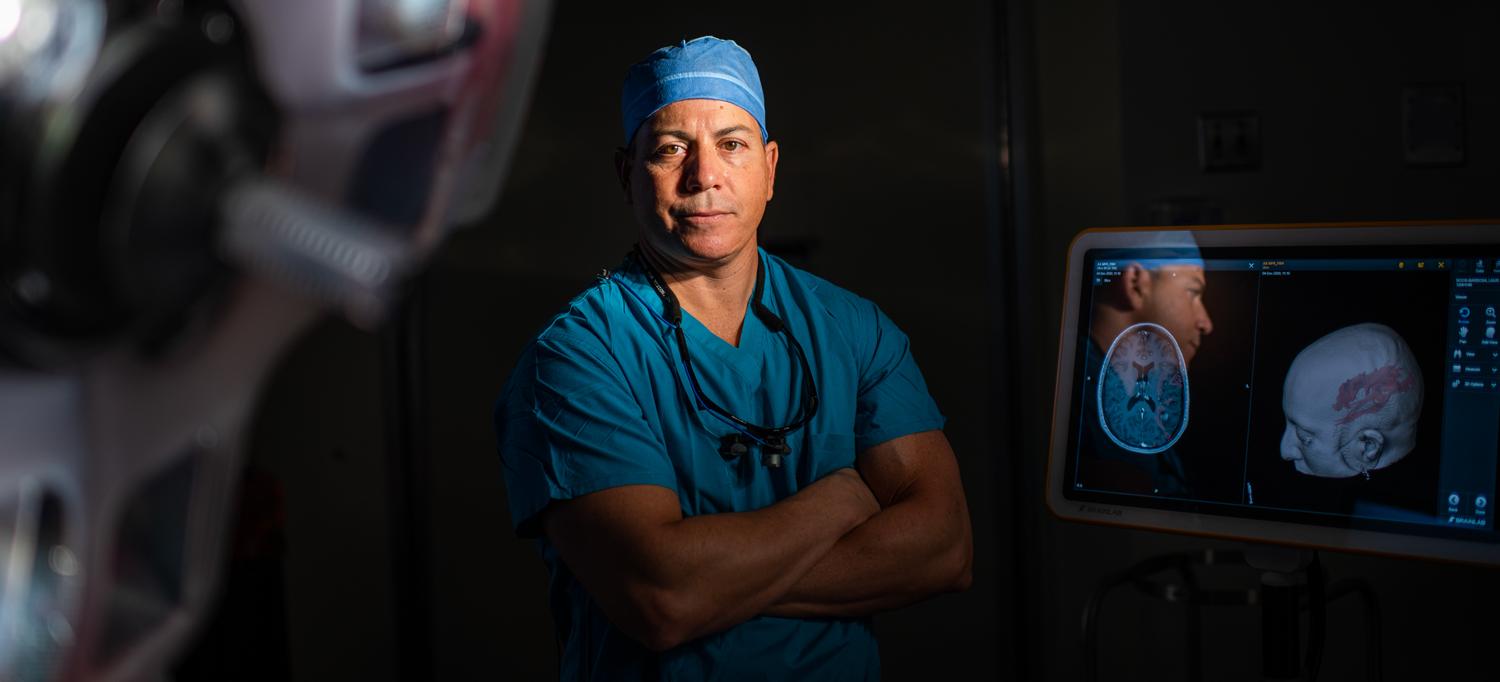 Wearing surgical scrubs, Dr. Lee Tessler stands in an operating room.