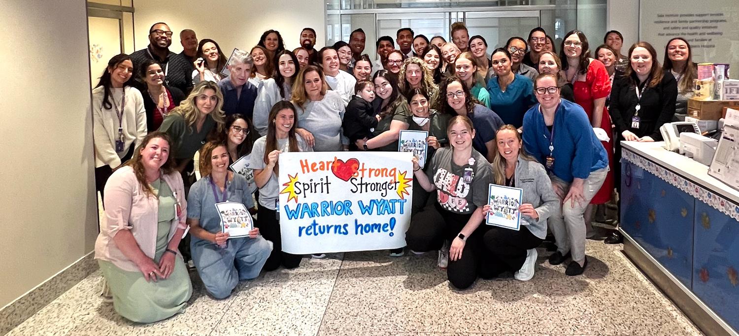 Two-year-old Wyatt poses with his care team.