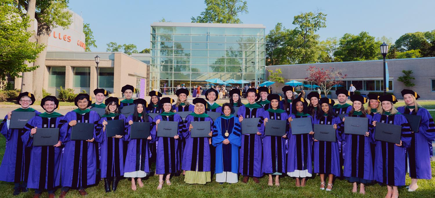 NYU Grossman Long Island School of Medicine’s 2026 graduating class poses with the dean, Dr. Gladys M. Ayala.