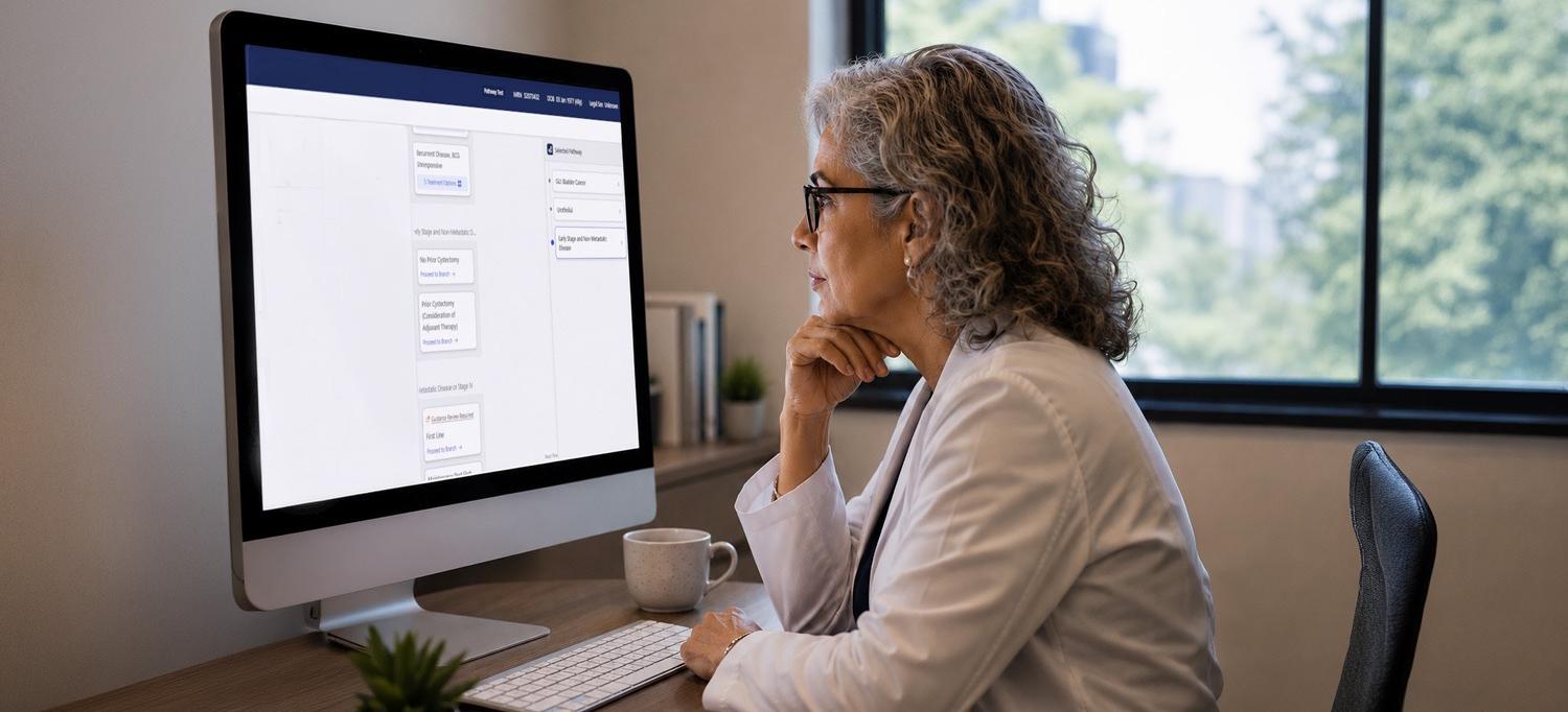 A clinician looks at a large computer monitor