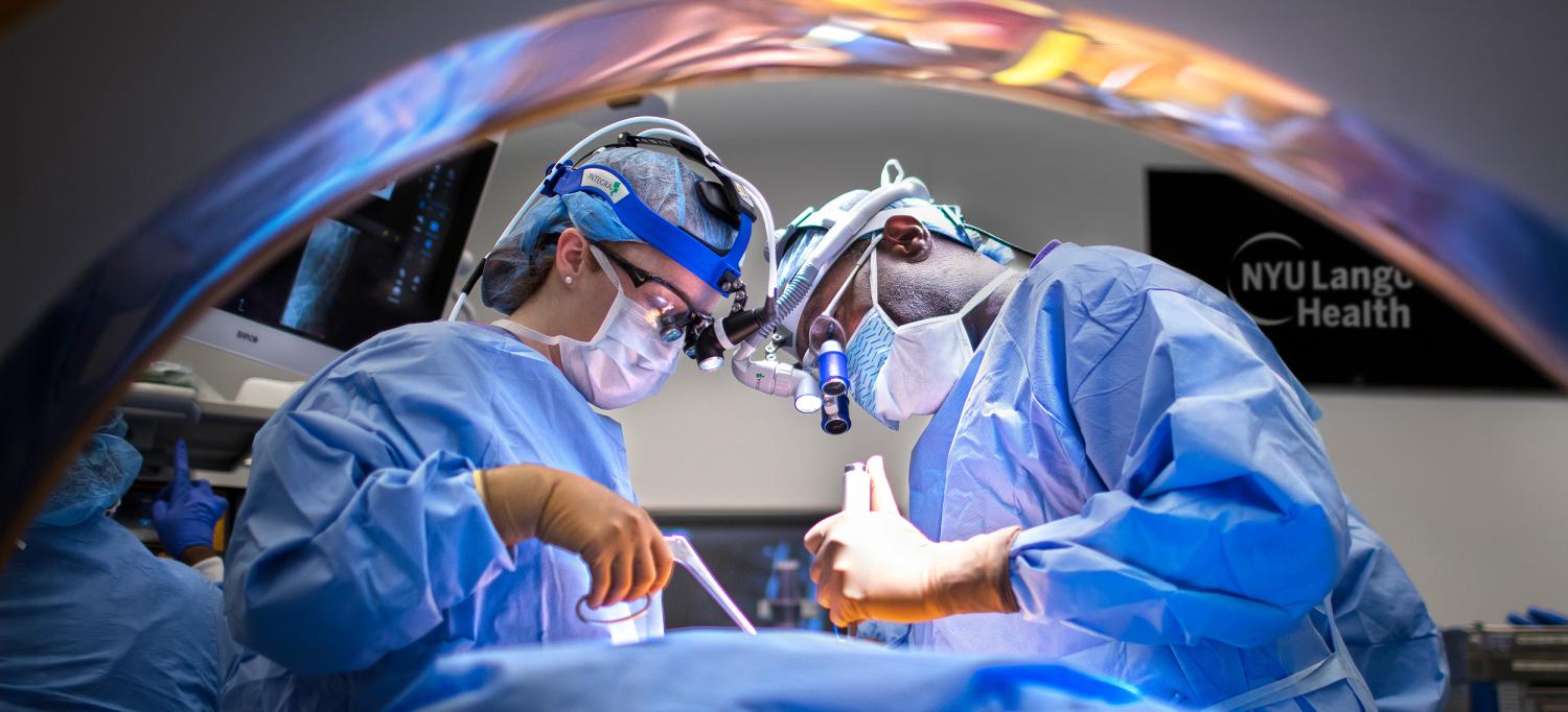 Two medical professionals in an operating room