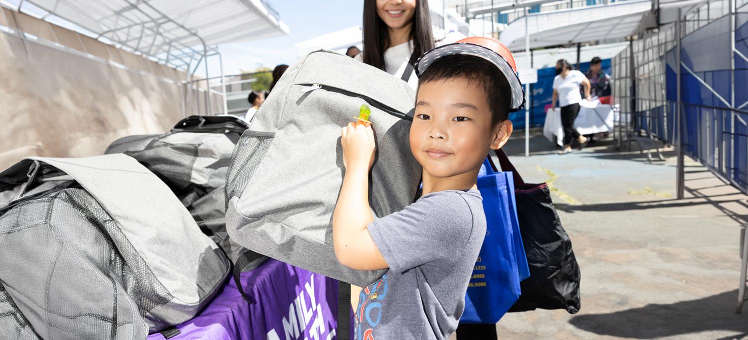 A schoolchild holds a backpage