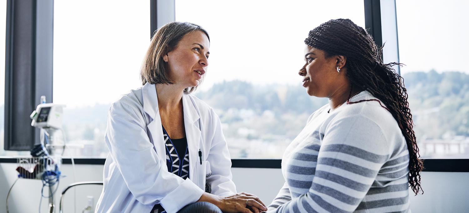 Female doctor counsels her patient. 