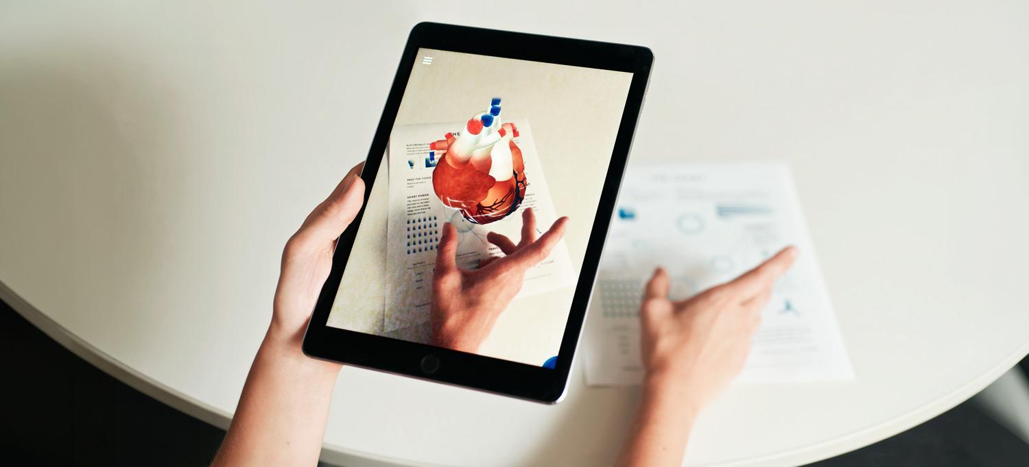 Hands holding a tablet