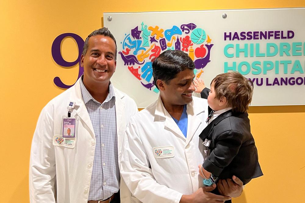 Boy with his surgeon and pediatric cardiologist.