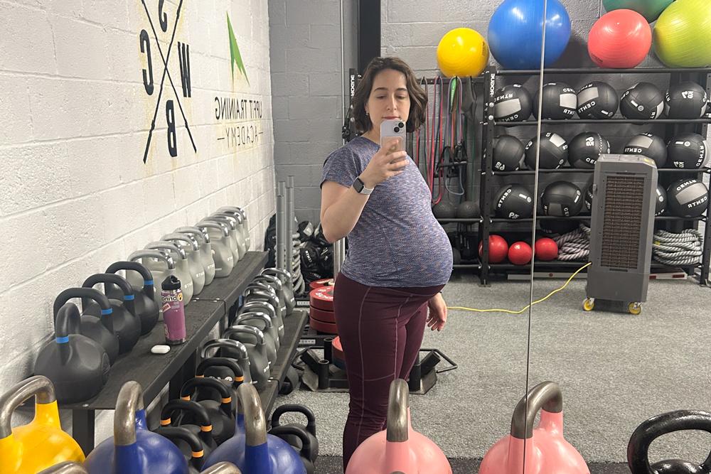 Pregnant woman in the gym with kettlebells