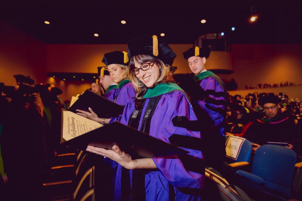 Student speaker Dr. Crystal Y. Mehdizadeh reads her diploma.