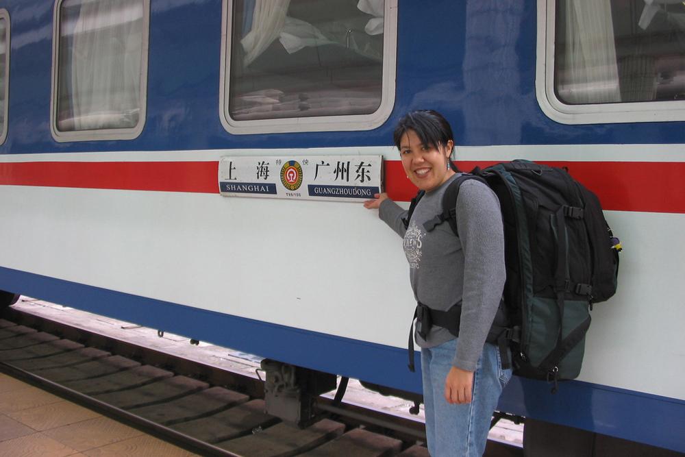 Rocha points to a train with a sign saying "Shanghai" and "Guangzhoudong."