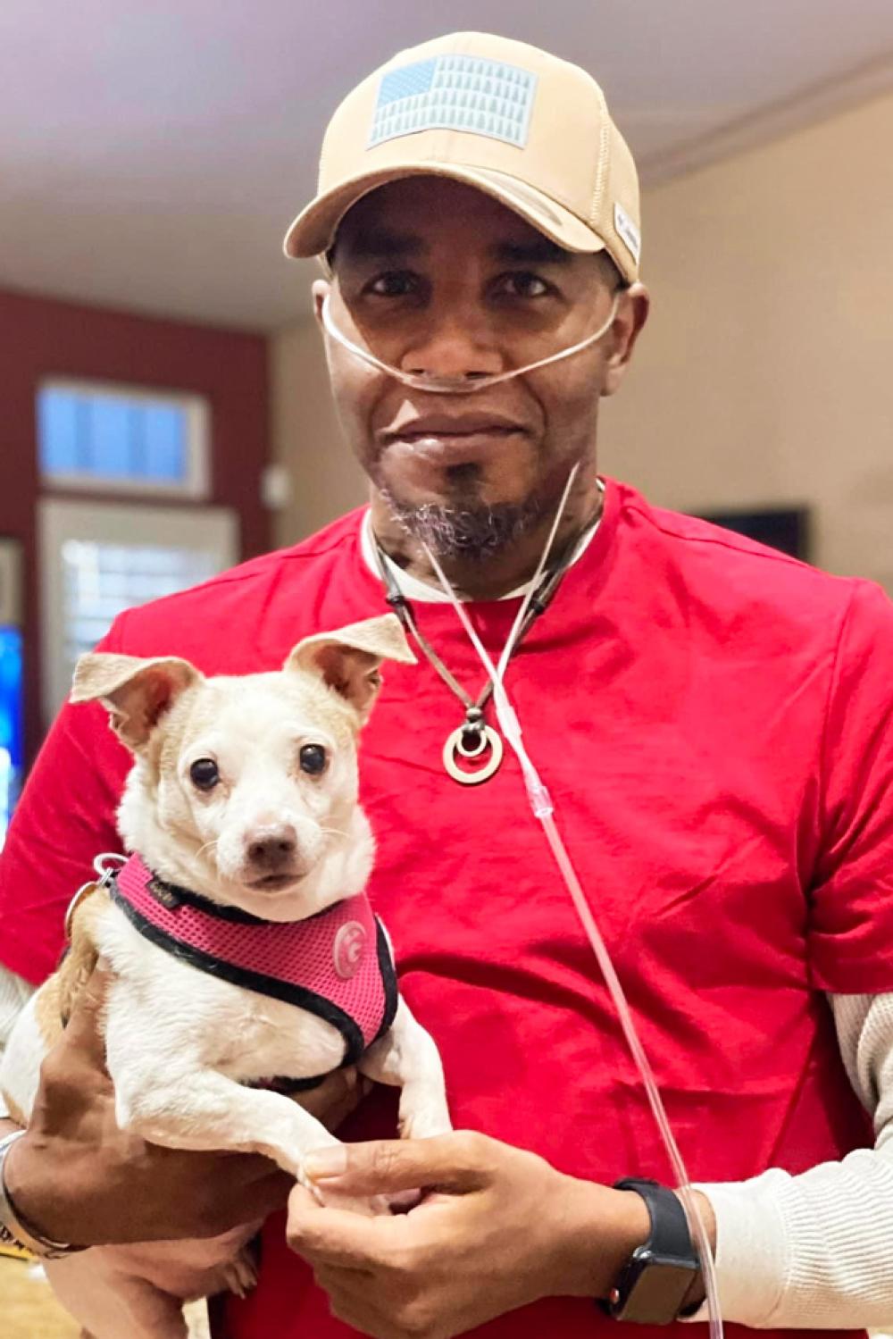 Bertrand Nelson holds his dog. 