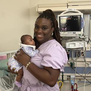 Phaebe Turner holds her daughter in a room in the NICU.