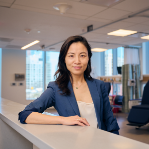 Dr. Kathy Huang pauses at the front desk of a patient care facility. 