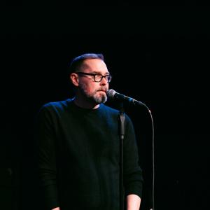 Bradley Lawrence at a microphone 