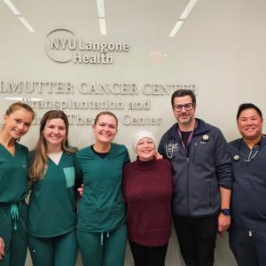 Patient poses with her medical team 