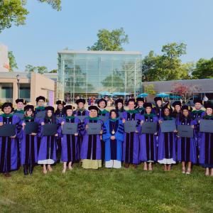 NYU Grossman Long Island School of Medicine’s 2026 graduating class poses with the dean, Dr. Gladys M. Ayala.