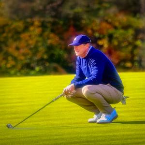 Pro golfer Scott Ford holds his gaze green after completing a powerful swing.