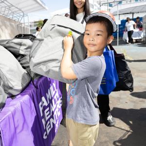 A schoolchild holds a backpage