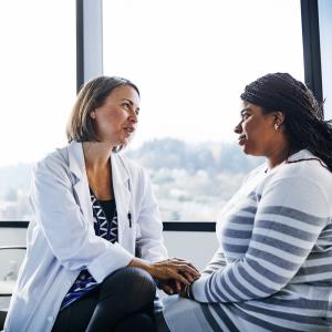 Female doctor counsels her patient. 