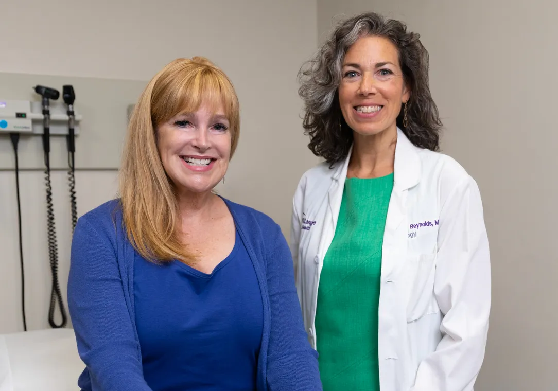 A patient sits next to Dr. Harmony Reynolds in an exam room.  